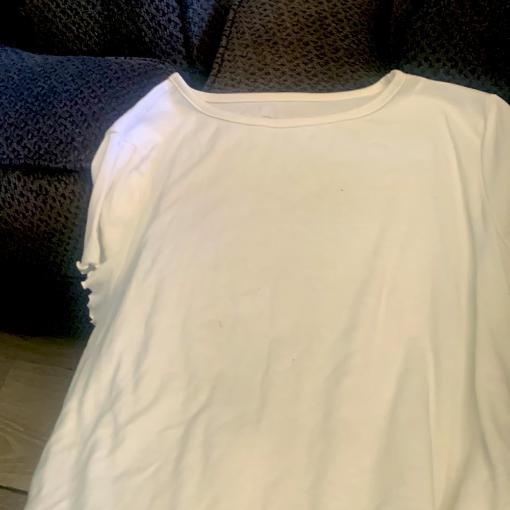 White shirt in ruffled in the bottom and hand sleeves